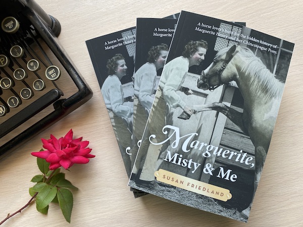 vintage typewriter with red rose and Marguerite Henry biography