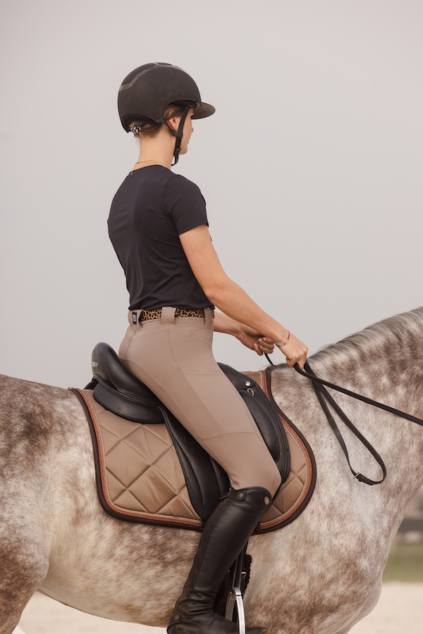 BOTORI Adler breeches in taupe with an equestrian riding a dapple gray horse; equestrian lifestyle; 2023 equestrian gift guide