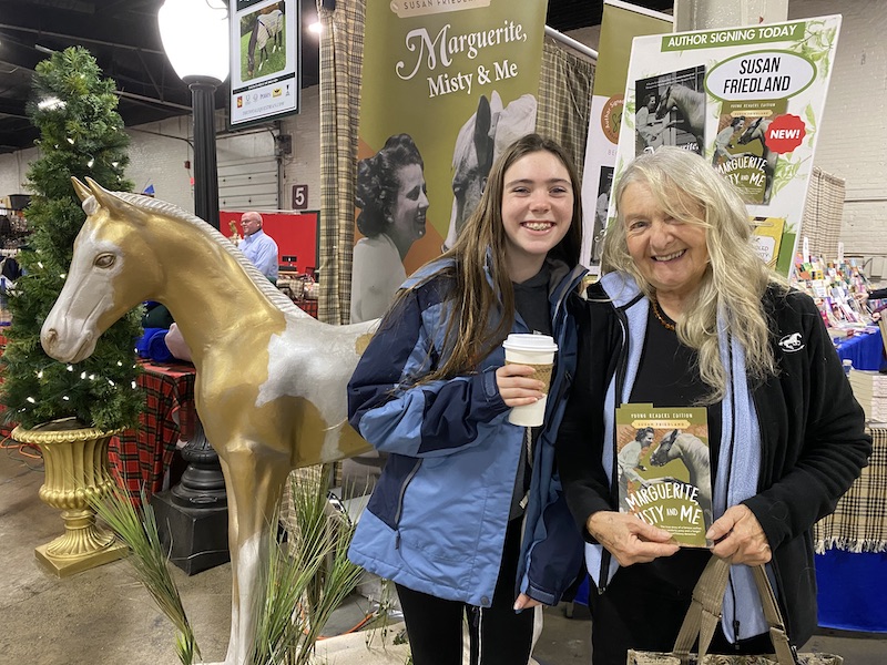 A grandma and granddaughter pose with Misty at Equine Affaire 